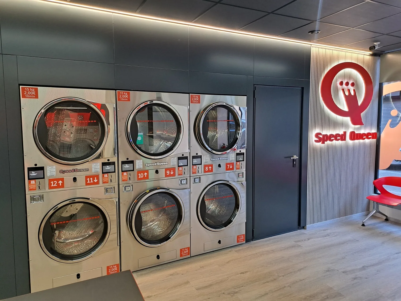 A stack of 15 kg Speed Queen dryers in a Gira Gira laundromat